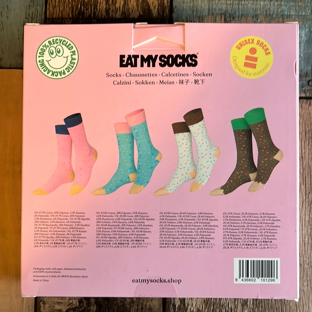 Joe's Donuts Socks. 4 Pair of fun socks in a donut box. Pair #1- Brown (Chocolate Donut) with " Sprinkles' Pair #2: White (Vanilla Donuts) with "Sprinkles. Pair #3- Blue (Blueberry Donuts) with "Sprinkles" Pair #4- Pink (Strawberry Donuts) with "Sprinkles" Brand: Eat My Socks