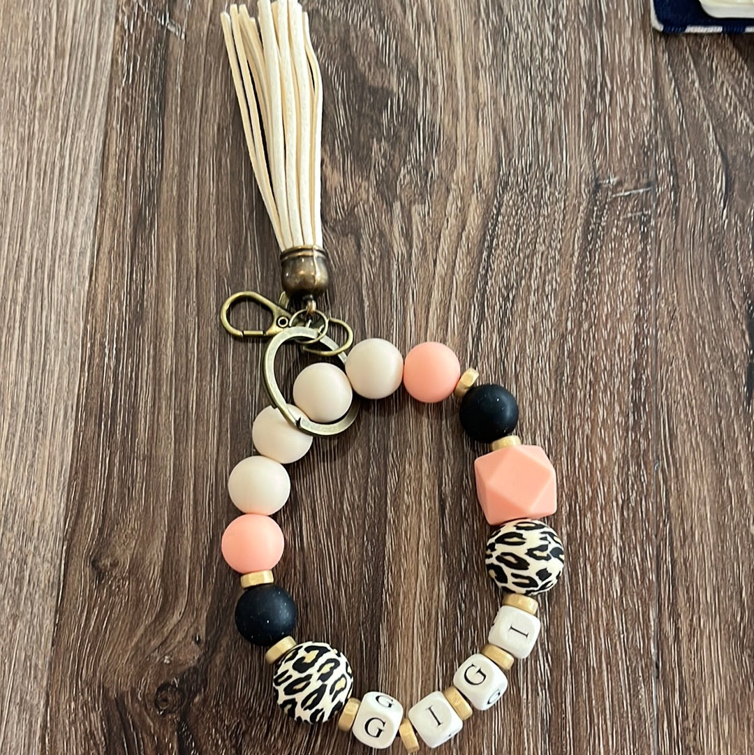 Gigi silicone beaded keychain wristlet animal print round and pink and black with natural tassels