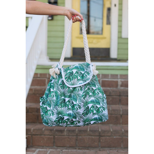 Rope handle beach bag with Palm Leaves.  Top flap closure. Polyester blend.  Bottom is approximately 23", top is approx. 17.5"
